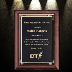 Wooden frame with green plaque and gold text